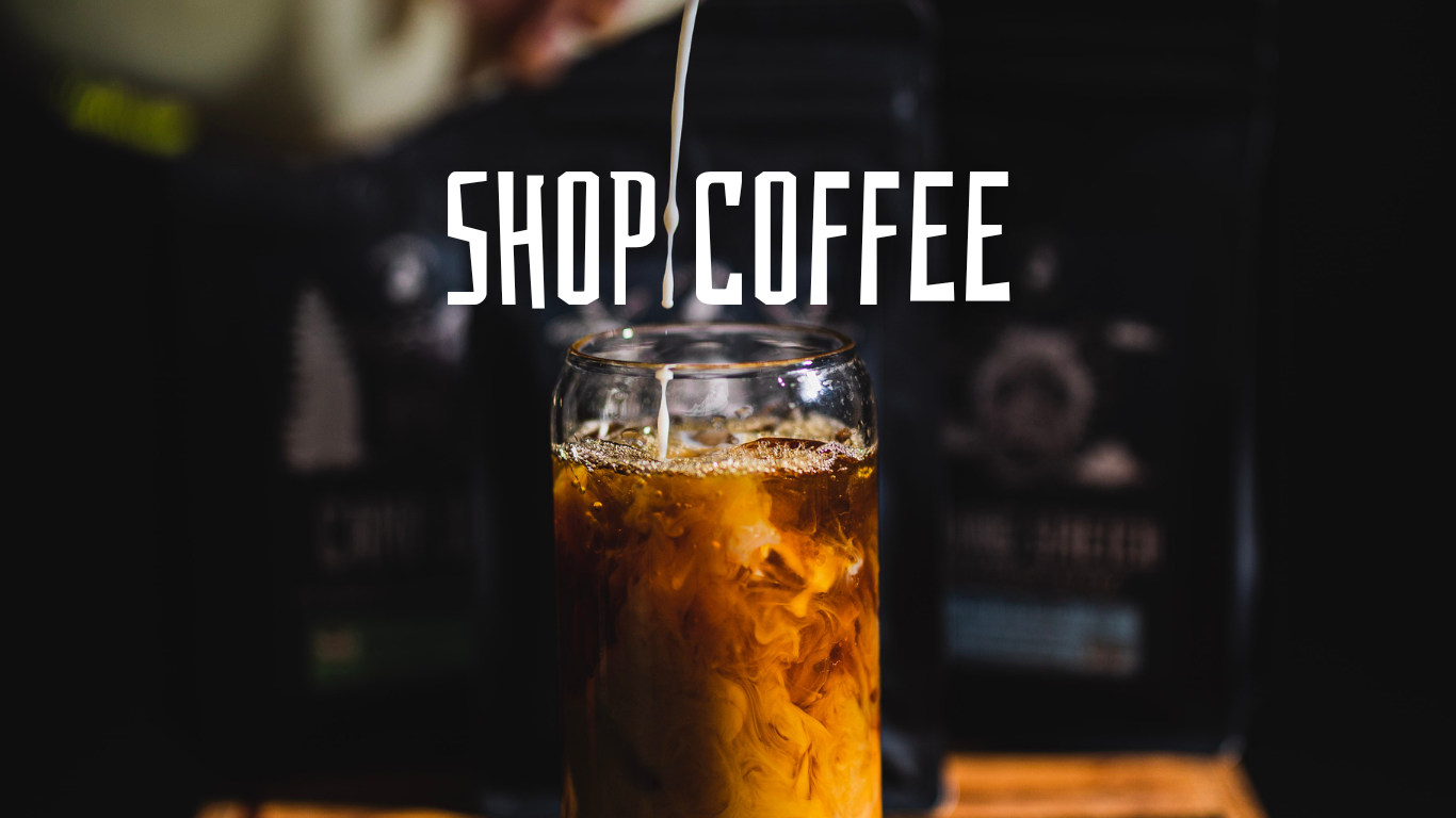 Text: Shop Coffee. Photo of milk being poured into a glass of coffee.
